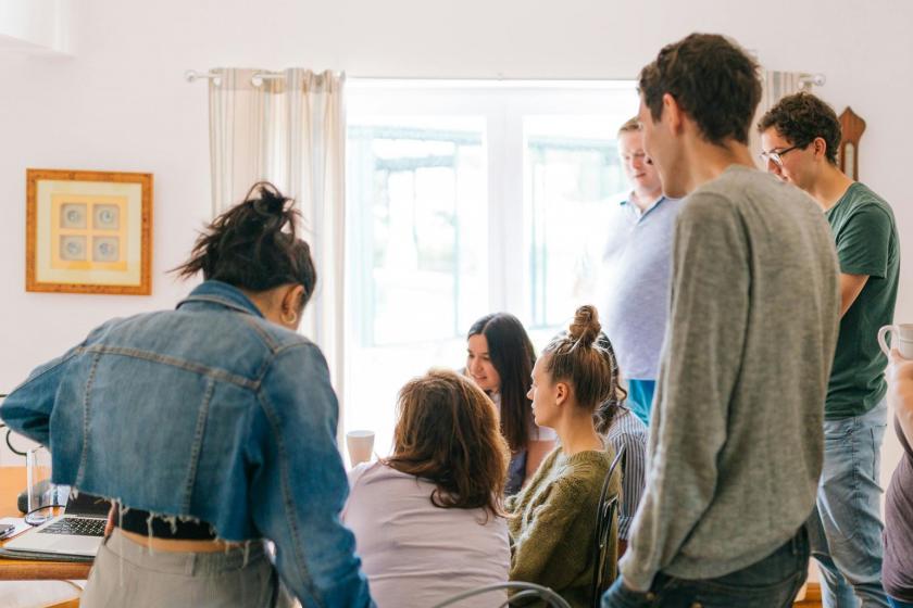 Fünf Personen, Die In Der Nähe Von Vier Personen Stehen, Die In Der Nähe Des Schreibtisches Sitzen